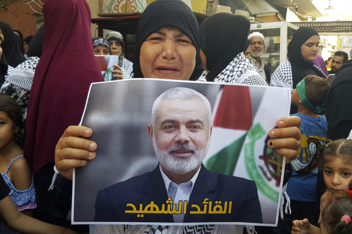 A supporter of the Islamist Hamas movement reacts as she holds a poster of Hamas political chief Ismail Haniyeh during a protest to condemn his killing, at the Palestinian refugee camp of Ein el-Hilweh near the southern port city of Sidon, Lebanon, Wednesday, July 31, 2024. Haniyeh, Hamas&rsquo; political chief in exile who landed on Israel&rsquo;s hit list after the militant group staged its surprise Oct. 7 attacks, was killed in an airstrike in the Iranian capital early Wednesday.