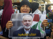 A supporter of the Islamist Hamas movement reacts as she holds a poster of Hamas political chief Ismail Haniyeh during a protest to condemn his killing, at the Palestinian refugee camp of Ein el-Hilweh near the southern port city of Sidon, Lebanon, Wednesday, July 31, 2024. Haniyeh, Hamas&rsquo; political chief in exile who landed on Israel&rsquo;s hit list after the militant group staged its surprise Oct. 7 attacks, was killed in an airstrike in the Iranian capital early Wednesday.