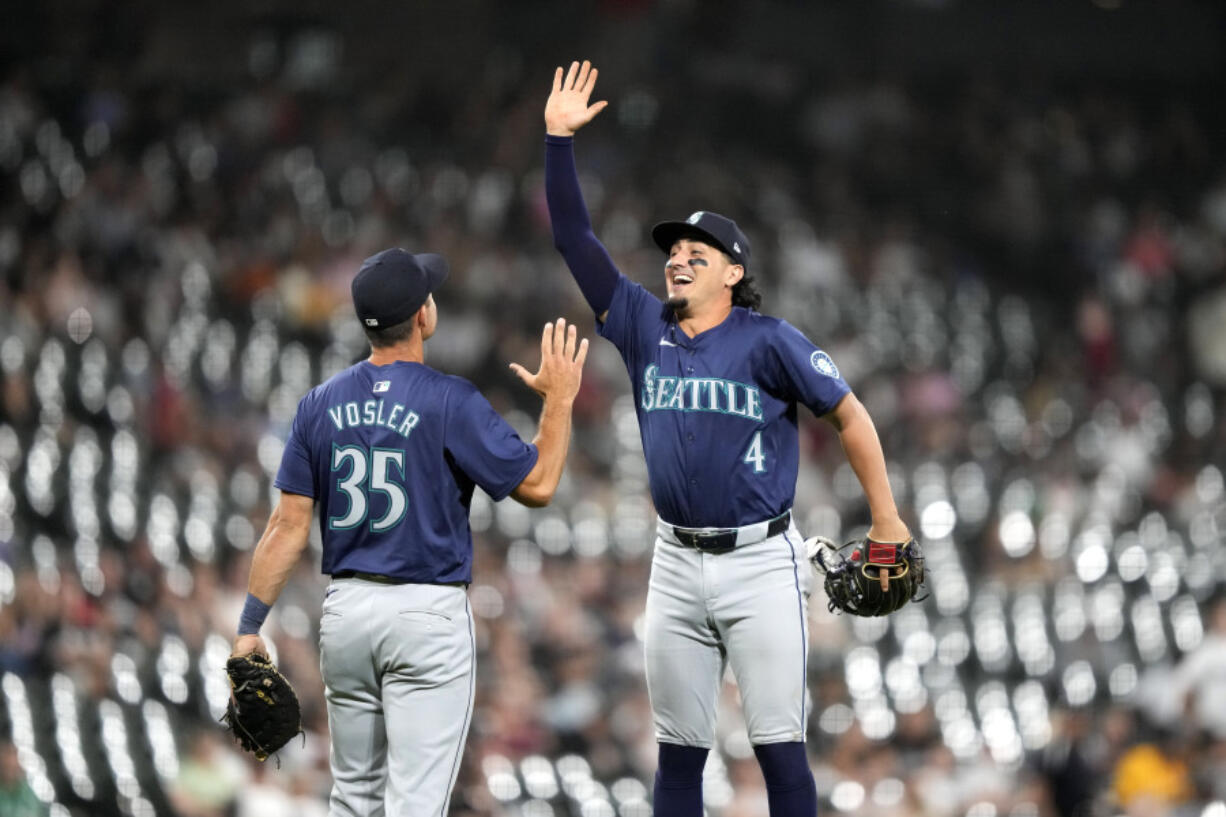 The Seattle Mariners&#039; Jason Vosler (35) and Josh Rojas celebrate their shutout of the Chicago White Sox in a baseball game Friday, July 26, 2024, in Chicago.