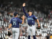 The Seattle Mariners&#039; Jason Vosler (35) and Josh Rojas celebrate their shutout of the Chicago White Sox in a baseball game Friday, July 26, 2024, in Chicago.