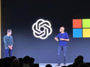 FILE - OpenAI CEO Sam Altman, left, appears onstage with Microsoft CEO Satya Nadella at OpenAI&rsquo;s first developer conference, on Nov. 6, 2023, in San Francisco. Microsoft has quit its seat on the board of OpenAI, saying its role is no longer needed because the ChatGPT maker has improved its governance since being roiled by boardroom chaos last year. In a letter sent on Tuesday, July 9, 2024,  Microsoft confirmed it was resigning, &ldquo;effective immediately,&rdquo; from its role as an observer on the board.