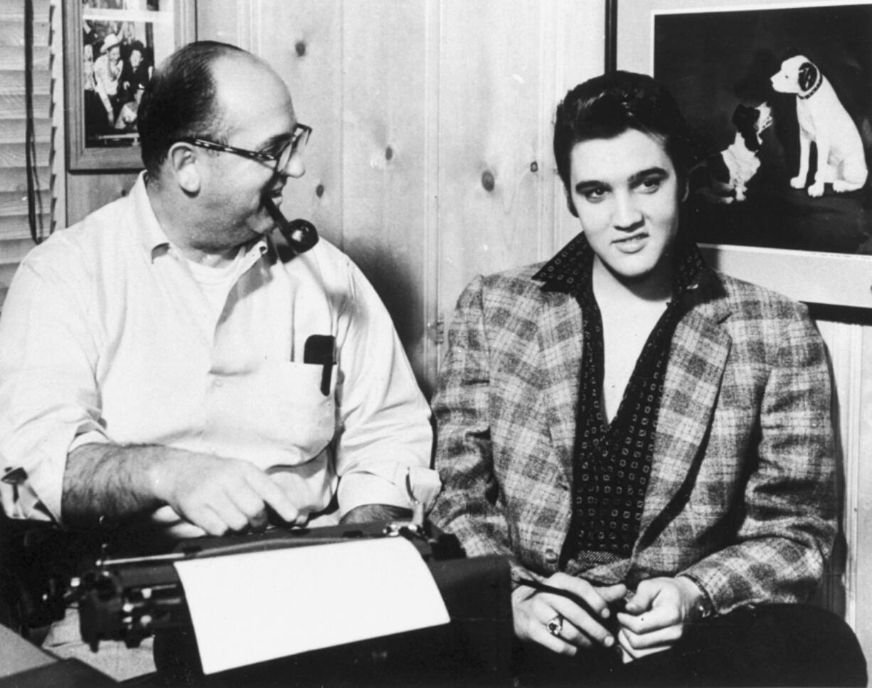 FILE - Tom Parker, left, of Madison, Tennessee, beams on protege Elvis Presley, January 7, 1957. Arthur Crudup wrote the song that became Elvis&rsquo; first single, &ldquo;That&rsquo;s All Right,&rdquo; but received scant songwriting royalties in his lifetime.