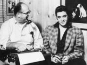 FILE - Tom Parker, left, of Madison, Tennessee, beams on protege Elvis Presley, January 7, 1957. Arthur Crudup wrote the song that became Elvis&rsquo; first single, &ldquo;That&rsquo;s All Right,&rdquo; but received scant songwriting royalties in his lifetime.