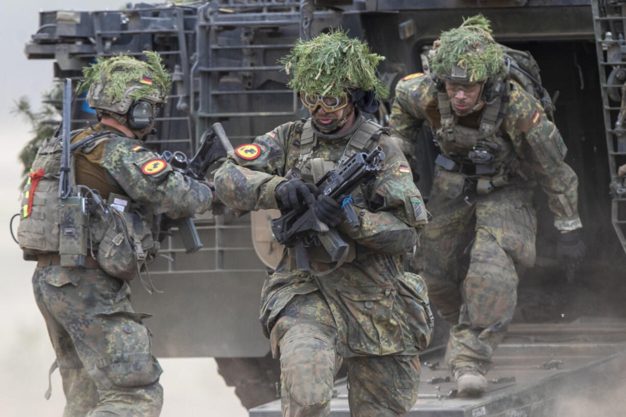 FILE - German soldiers take part in the Lithuanian-German division-level international military exercise &lsquo;Grand Quadriga 2024&rsquo; at a training range in Pabrade, north of the capital Vilnius, Lithuania on Wednesday, May 29, 2024. After relying on U.S. leadership of NATO to protect them for the past 75 years, European nations must take on a larger role in funding and leading the 32-nation alliance because their interests are increasingly diverging from those of the United States.