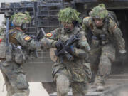 FILE - German soldiers take part in the Lithuanian-German division-level international military exercise &lsquo;Grand Quadriga 2024&rsquo; at a training range in Pabrade, north of the capital Vilnius, Lithuania on Wednesday, May 29, 2024. After relying on U.S. leadership of NATO to protect them for the past 75 years, European nations must take on a larger role in funding and leading the 32-nation alliance because their interests are increasingly diverging from those of the United States.