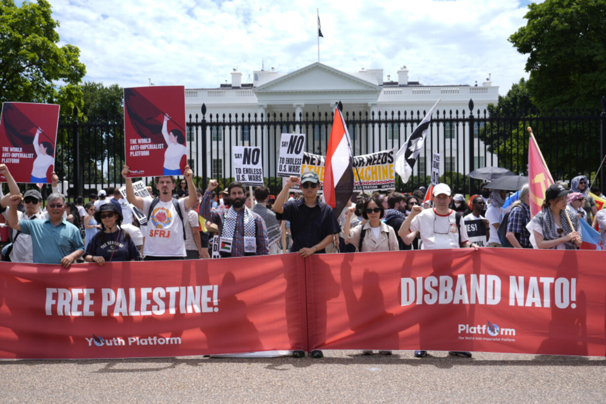 People from various groups protest outside the White House in Washington, Sunday, July 7, 2024.