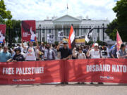 People from various groups protest outside the White House in Washington, Sunday, July 7, 2024.