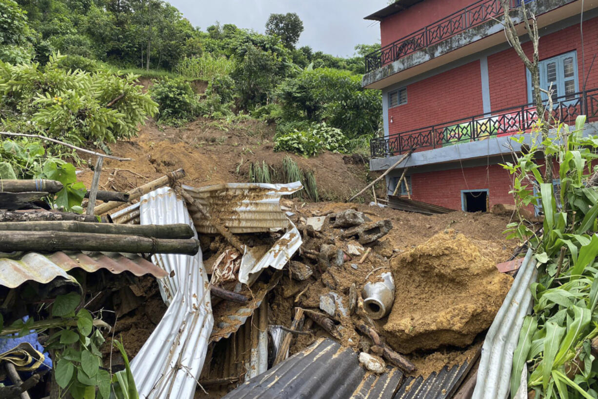 Damaged houses knocked by landslides are seen on the outskirts Pokhara, Nepal, Friday, July 12, 2024.