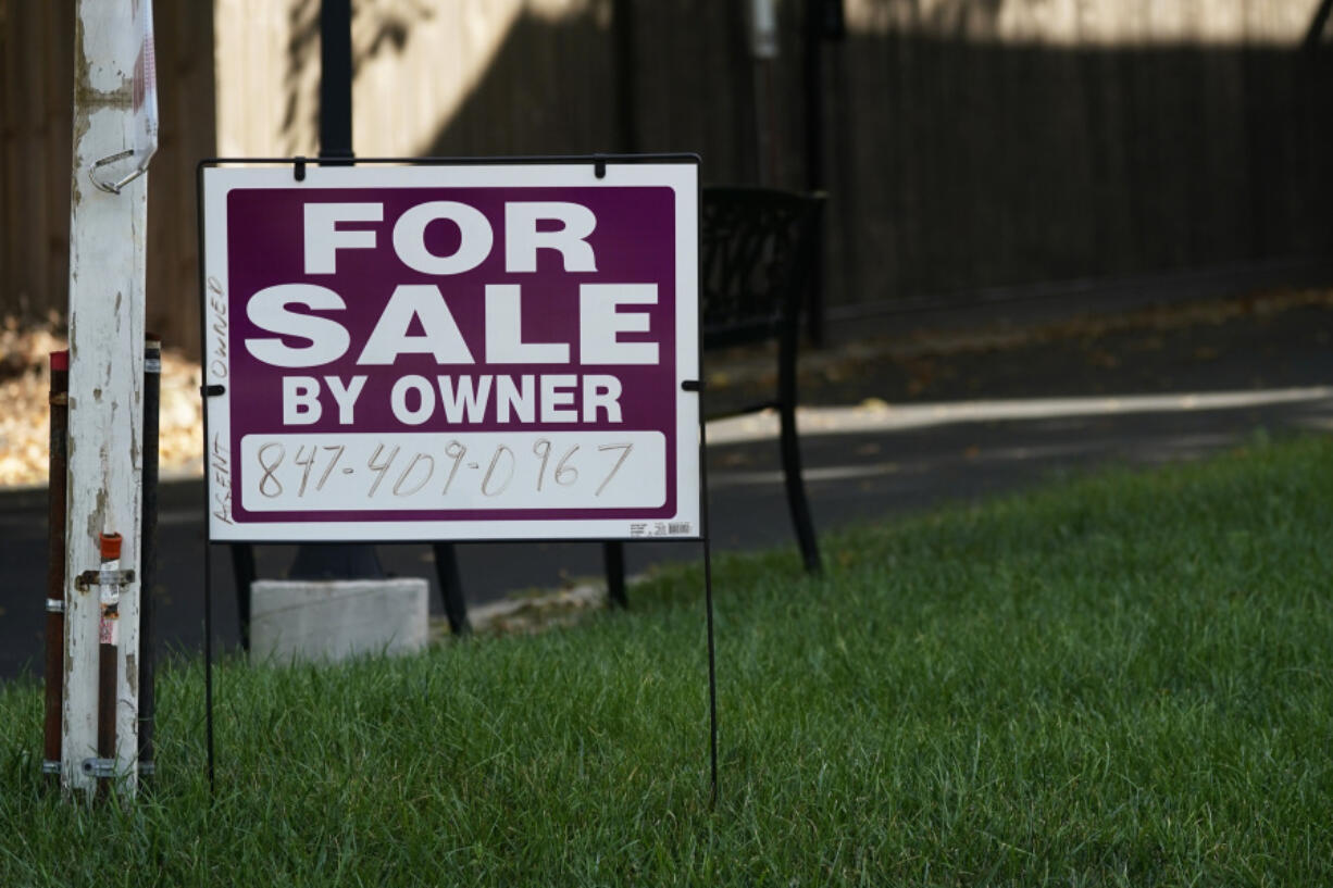 FILE - For sale by owner sign is displayed in Northbrook, Ill., Wednesday, Sept. 21, 2022. Sales of U.S. homes to foreign nationals have fallen to the lowest level in more than a decade, hampered by a strong dollar and many of the affordability hurdles that have kept the housing market in a deep sales slump for over two years. (AP Photo/Nam Y.