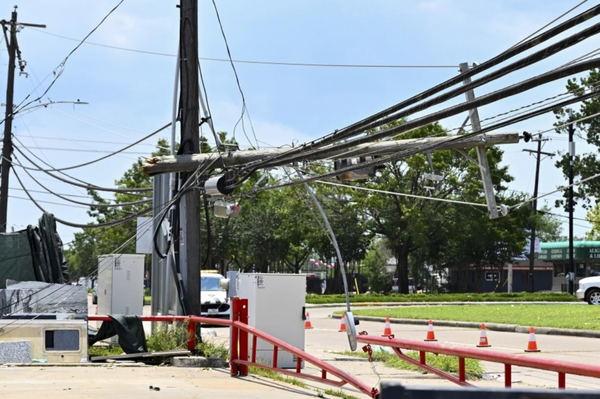 FILE - Utility polls wait for repair after being damaged by Hurricane Beryl in Houston, July 10, 2024. Destructive storms like Hurricane Beryl that knocked out power to 3 million homes and businesses in Texas are growing more frequent and intense, and insurers are jacking up rates in response.