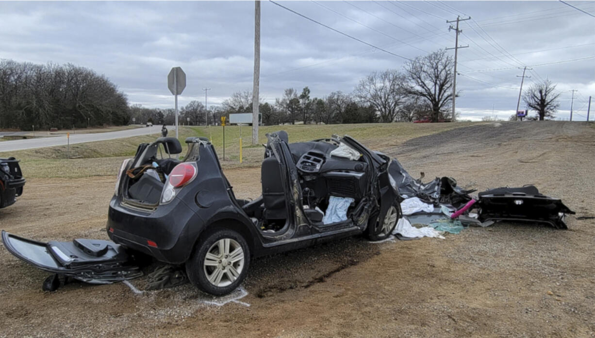 FILE - In this image provided by KFOR-TV, a heavily damaged vehicle is seen off a road in Tishomingo, Okla., following a two-vehicle collision in which six teenage students were killed, March 22, 2022. The crash has the National Transportation Safety Board urging parents to warn teenagers about the risk of driving after using marijuana.