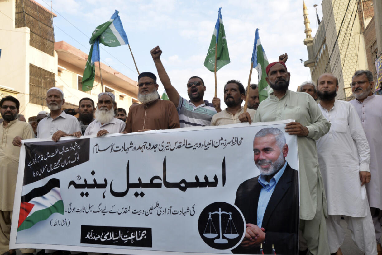 Supporters of the Pakistani religious group &ldquo;Jamaat-e-Islami&rdquo; hold a poster of Hamas leader Ismail Haniyeh during a protest to condemn his killing, in Hyderabad, Pakistan, Wednesday, July 31, 2024. Haniyeh was assassinated in Tehran, Iran&rsquo;s paramilitary Revolutionary Guard said early Wednesday.