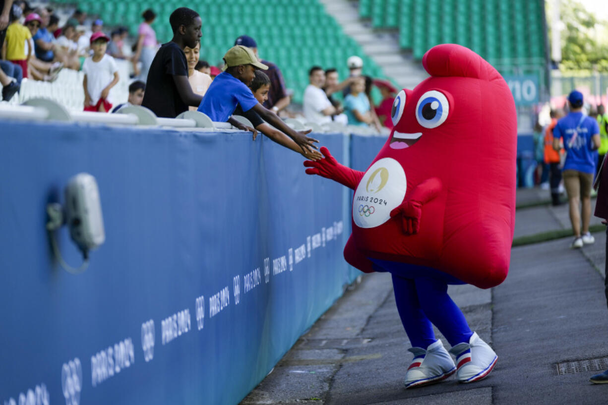 The mascot for the Olympics greets fans prior to the women&rsquo;s Group A soccer match between Canada and New Zealand at Geoffroy-Guichard stadium during the 2024 Summer Olympics, Thursday, July 25, 2024, in Saint-Etienne, France.