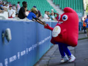 The mascot for the Olympics greets fans prior to the women&rsquo;s Group A soccer match between Canada and New Zealand at Geoffroy-Guichard stadium during the 2024 Summer Olympics, Thursday, July 25, 2024, in Saint-Etienne, France.