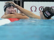 Torri Huske, left, of the United States, reacts after winning the women&#039;s 100-meter butterfly final with teammate Gretchen Walsh at the 2024 Summer Olympics, Sunday, July 28, 2024, in Nanterre, France.