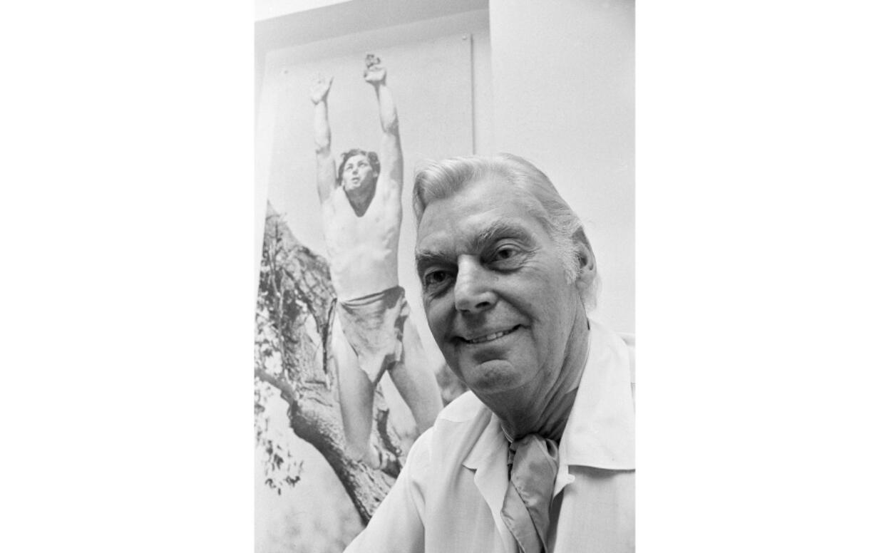 Olympic hero and film actor Johnny Weissmuller is pictured June 29, 1971, in front of a photo of himself as Tarzan.