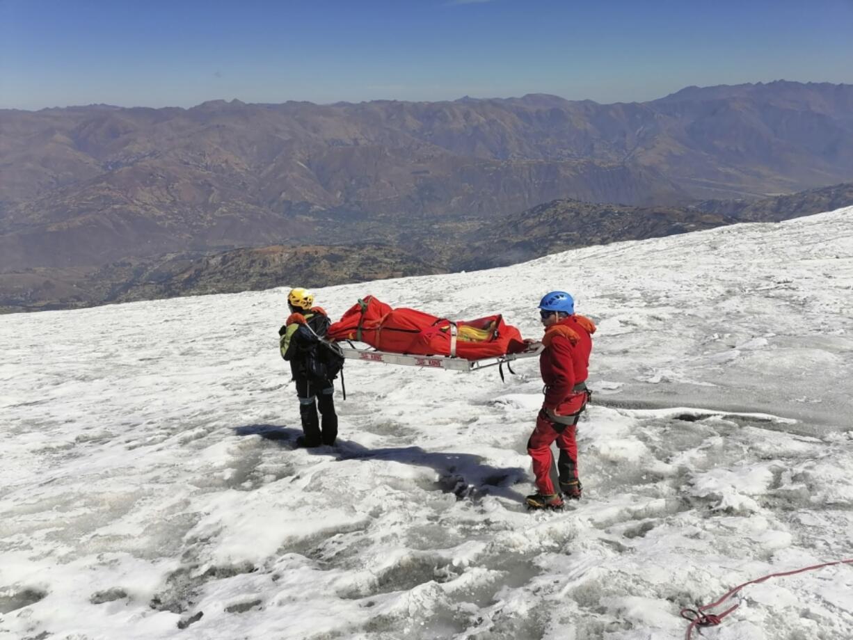 This photo distributed by the Peruvian National Police shows police carrying a body that they identify as U.S. mountain climber William Stampfl, on Huascaran mountain in Huaraz, Peru, July 5, 2024. Peruvian authorities announced on Tuesday, July 9, 2024, that they have found the mummified body of the American man who died 22 years ago, along with two other American climbers, after the three were trapped in an avalanche while trying to climb Peru&#039;s highest mountain.