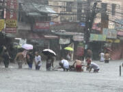 Streets flooded as monsoon rains worsened by offshore typhoon Gaemi on Wednesday, July 24, 2024, in Manila, Philippines.