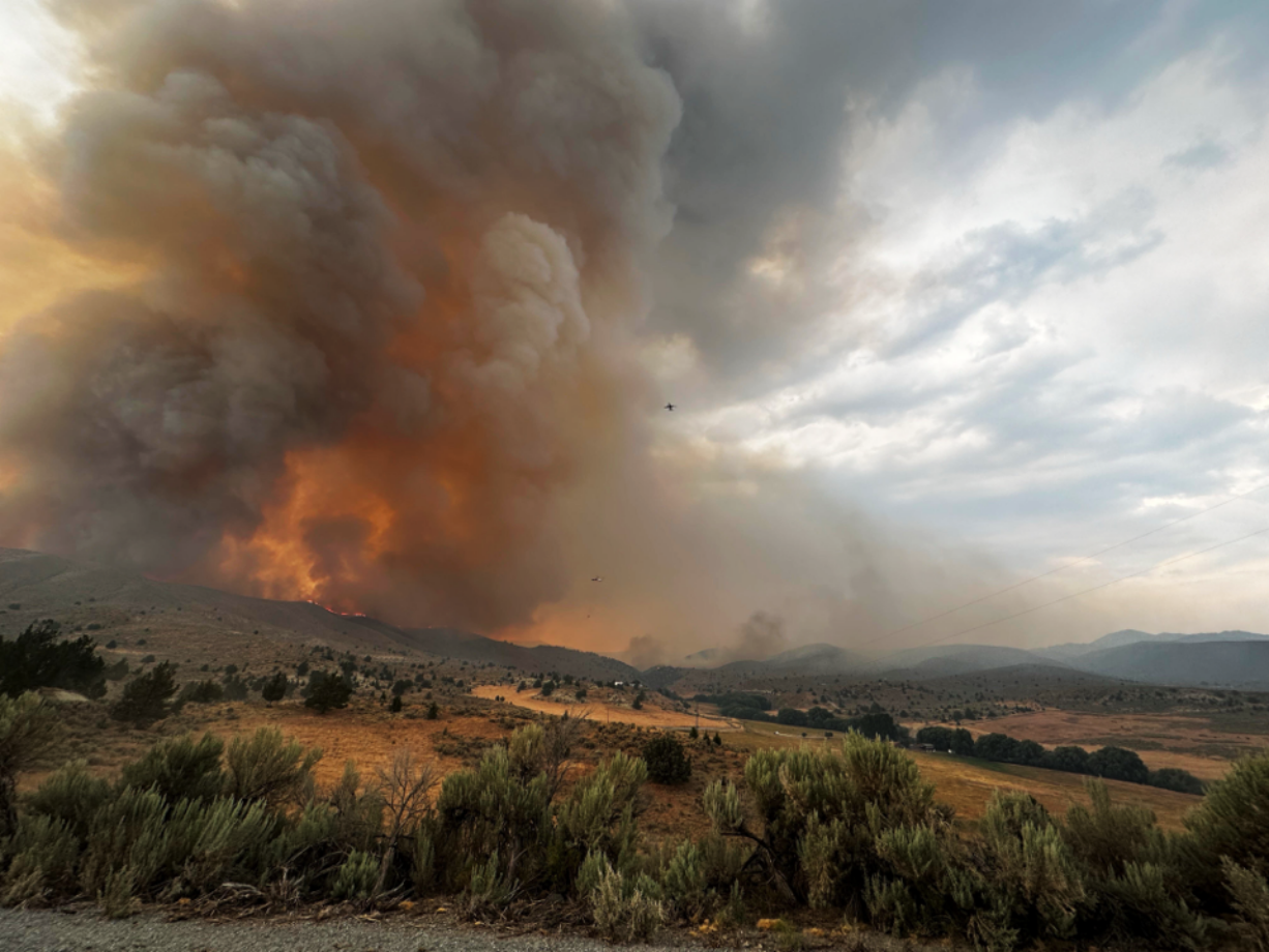 Aircraft aid in an initial attack on the wildfire burning south of Baker City, Ore., on July 22.