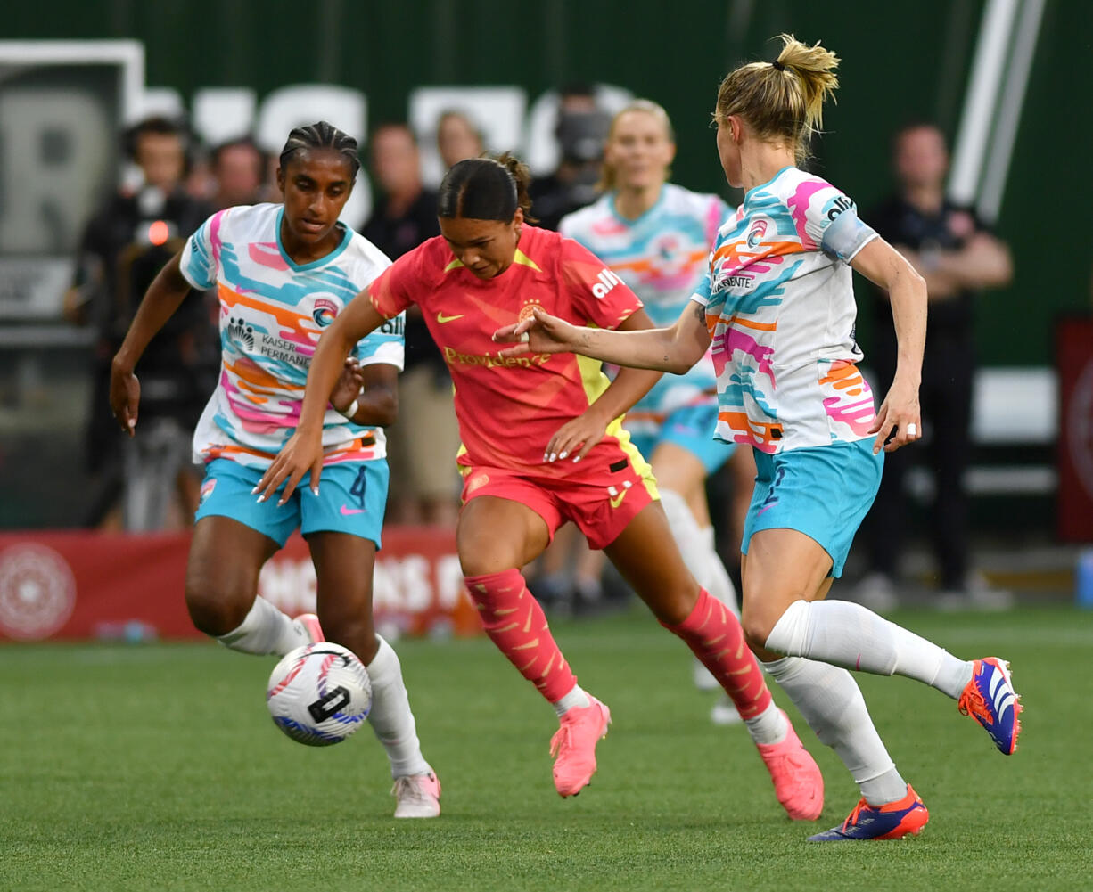 Portland forward Sophia Smith, center, weaves between defenders Friday, July 5, 2024, during the Thorns’ 1-0 win against San Diego Wave FC at Providence Park in Portland.