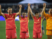 Portland forward Christine Sinclair, from left, midfielder Marissa Sheva, midfielder Hina Sugita and goalkeeper Lauren Kozal raise their arms Friday, July 5, 2024, after the Thorns’ 1-0 win against San Diego Wave FC at Providence Park in Portland.