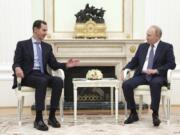 Syrian President Bashar Assad, left, speaks with Russian President Vladimir Putin during their meeting in Moscow, Russia, Wednesday, July 24, 2024.
