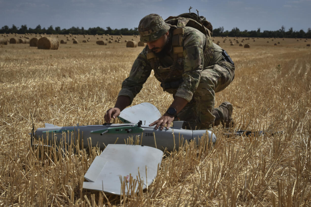 A soldier of Ukraine&rsquo;s National Guard 15th Brigade works with a recon-naissance drone in a wheat field to determine Russian positions Monday near the front line in the Zaporizhzhia region of Ukraine.