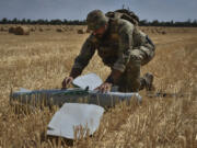 A soldier of Ukraine&rsquo;s National Guard 15th Brigade works with a recon-naissance drone in a wheat field to determine Russian positions Monday near the front line in the Zaporizhzhia region of Ukraine.