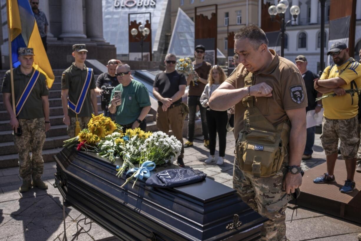 Comrade of British combat medic, volunteer, Peter Fouche, 49 who was killed on June 27 during his work in East Ukraine, says his last goodbye at the funeral ceremony on the city&#039;s main square in Kyiv, Ukraine, Saturday, July 6, 2024. Peter was founder of a charity organization, which provides vehicles, drones and other needs to Ukrainian servicemen.