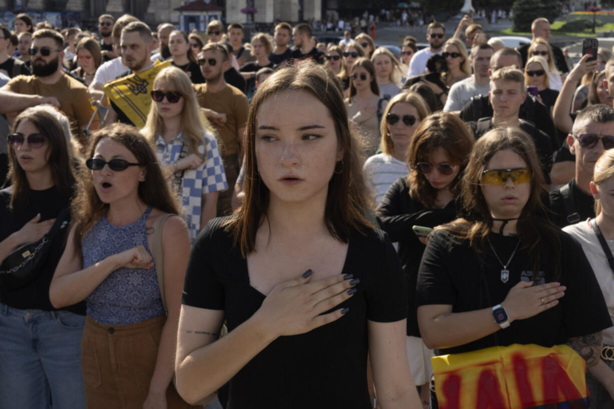 People sing the national anthem at a rally demanding to free Ukrainian prisoners of war who are held in captivity in Russia, at Independence Square in Kyiv, Ukraine, Sunday, July 28, 2024. Several thousand people and soldiers gathered to commemorate the second anniversary of a Russia-orchestrated explosion that killed more than 50 Ukrainian prisoners of war in the Russian-held Olenivka prison barracks.