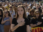 People sing the national anthem at a rally demanding to free Ukrainian prisoners of war who are held in captivity in Russia, at Independence Square in Kyiv, Ukraine, Sunday, July 28, 2024. Several thousand people and soldiers gathered to commemorate the second anniversary of a Russia-orchestrated explosion that killed more than 50 Ukrainian prisoners of war in the Russian-held Olenivka prison barracks.