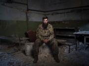Sgt. Kyrylo Masalitin, known as Maslo, who survived the explosion at the Russian-controlled Olenivka prison two years ago that killed more than 50 Ukrainian POWs, sits for a portrait in Lyman, Donetsk region, Ukraine, Thursday, July 11, 2024. &ldquo;In front of my eyes, there were guys who were dying, who were being revived, but it was all in vain,&rdquo; said Masalitin.