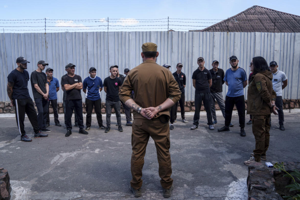 Prisoners listen to a Ukrainian sergeant of the Battalion Arey during an interview in a prison, in the Dnipropetrovsk region, Ukraine, Friday, June 21, 2024. Ukraine is expanding its military recruiting to cope with battlefield shortages more than two years into fighting Russia&rsquo;s full-scale invasion.