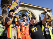 FILE - SAG-AFTRA captains Iris Liu, left, and Miki Yamashita, center, and SAG-AFTRA chief negotiator Duncan Crabtree-Ireland lead a cheer for striking actors outside Paramount Pictures studio, Nov. 3, 2023, in Los Angeles. Hollywood&rsquo;s video game performers voted to go on strike Thursday, July 25, 2024, throwing part of the entertainment industry into another work stoppage after talks for a new contract with major game studios broke down over artificial intelligence protections.