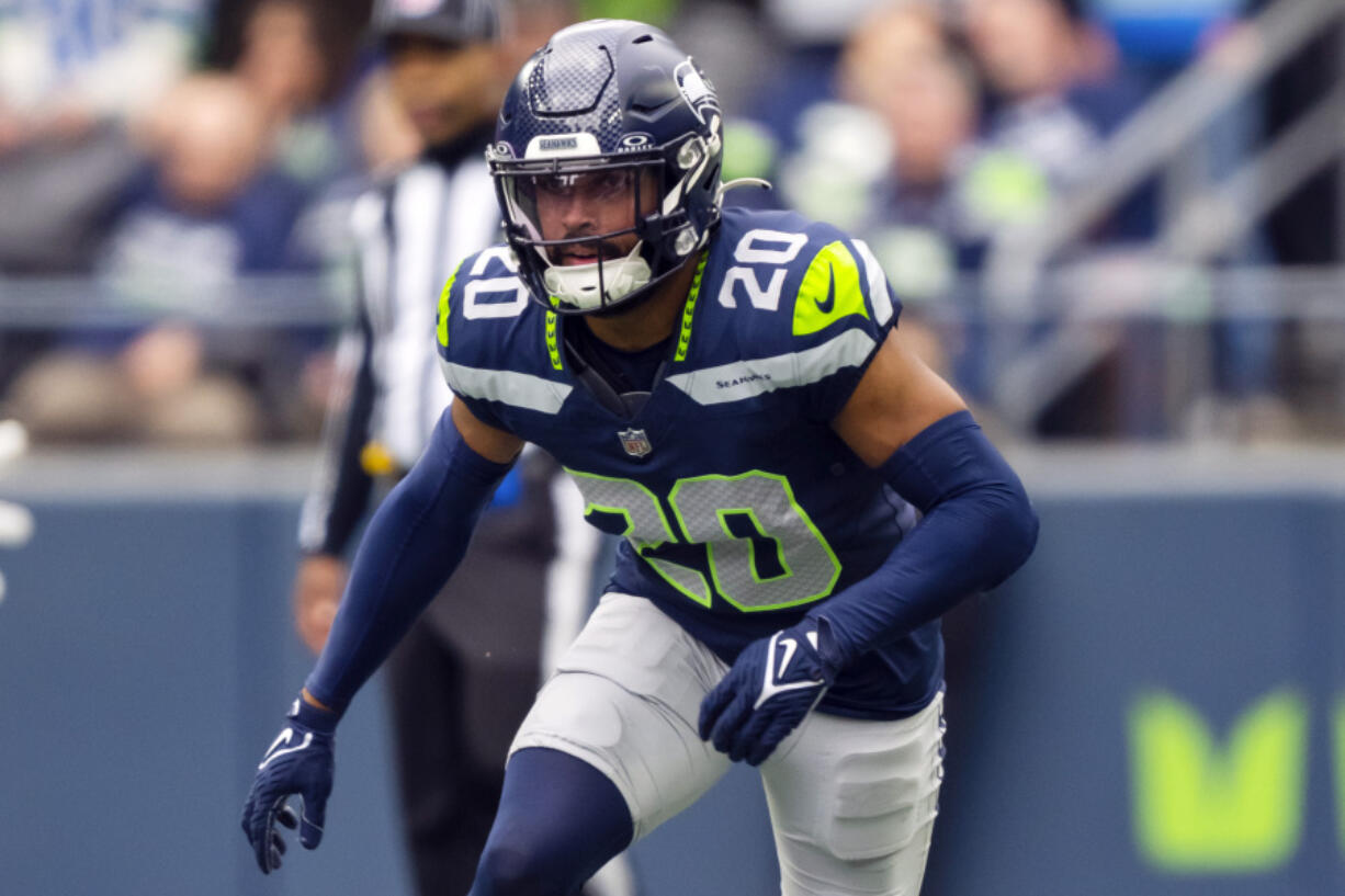 FILE - Seattle Seahawks safety Julian Love (20) runs during an NFL football game against the Arizona Cardinals, Sunday, Oct. 22, 2023 in Seattle. The Seahawks and Love have reached agreement on a three-year extension that could be worth up to $36 million.