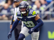 FILE - Seattle Seahawks safety Julian Love (20) runs during an NFL football game against the Arizona Cardinals, Sunday, Oct. 22, 2023 in Seattle. The Seahawks and Love have reached agreement on a three-year extension that could be worth up to $36 million.