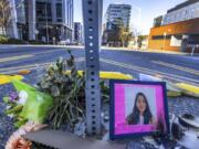FILE - A photo of Jaahnavi Kandula is displayed with flowers, Jan. 29, 2023 in Seattle. A Seattle police officer has been fired for making callous remarks about the death of a graduate student from India after she was struck by another officer&rsquo;s vehicle in a crosswalk last year.