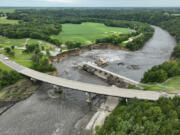 Floodwater continues to carve a channel around the Rapidan Dam on June 27 near Mankato, Minn.