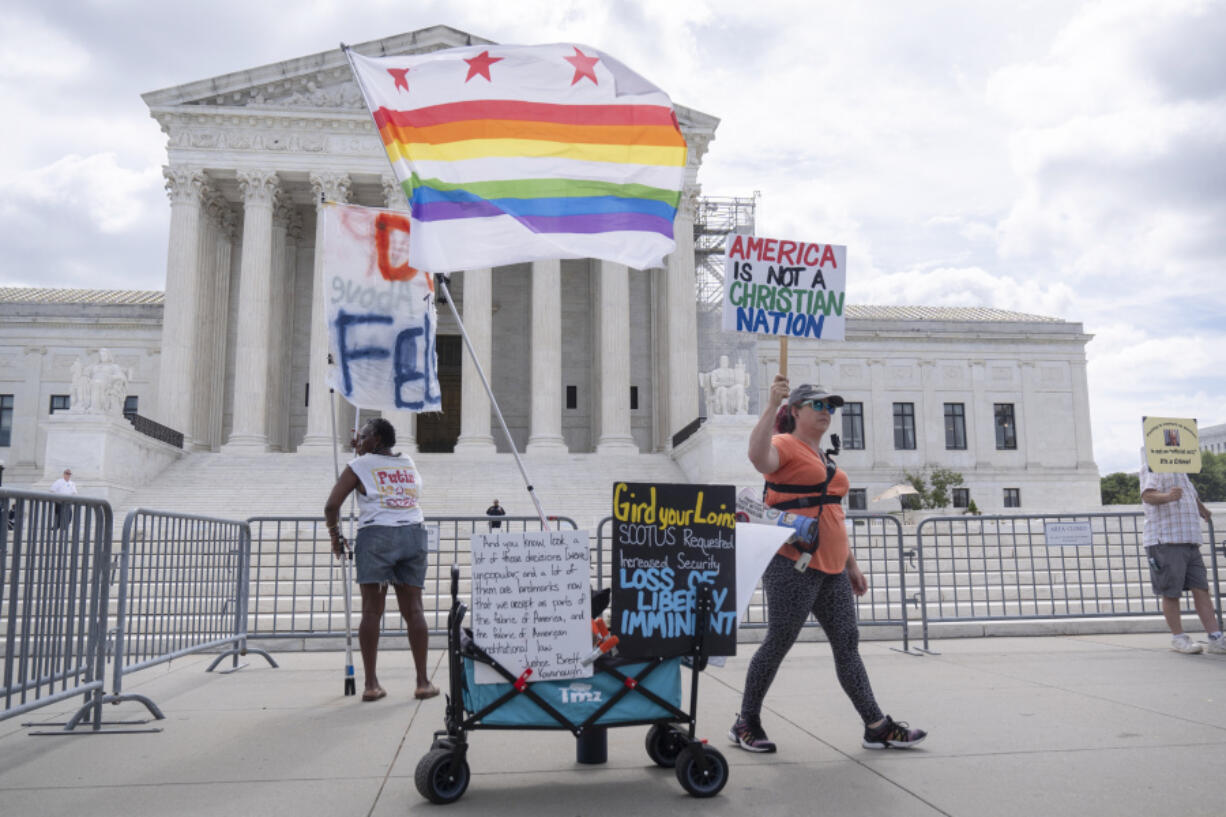 Demonstrators stand outside the Supreme Court on Thursday, June 27, 2024, in Washington. The Supreme Court cleared the way Thursday for Idaho hospitals to provide emergency abortions for now in a procedural ruling that left key questions unanswered and could mean the issue ends up before the conservative-majority court again soon.