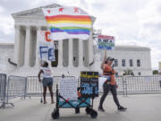 Demonstrators stand outside the Supreme Court on Thursday, June 27, 2024, in Washington. The Supreme Court cleared the way Thursday for Idaho hospitals to provide emergency abortions for now in a procedural ruling that left key questions unanswered and could mean the issue ends up before the conservative-majority court again soon.