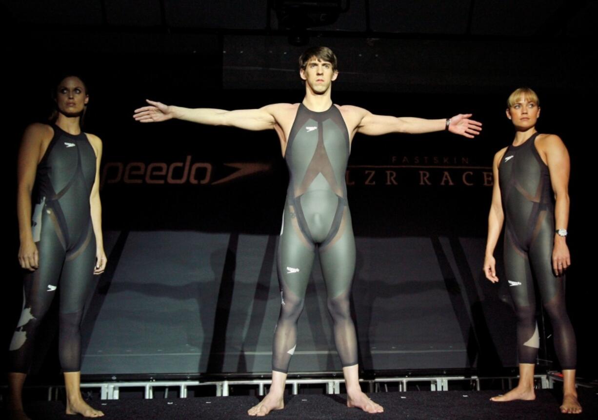 FILE - American Olympic medalists Amanda Beard, left, Natalie Coughlin, right, and Michael Phelps pose in Speedo &ldquo;LZR Racer&rdquo; swimsuits during a news conference introducing the suits in New York, Feb. 12, 2008. The iconic LZR Racer, the swimsuit that Michael Phelps wore while winning eight golds medals at the Beijing Olympics, is still revered around Speedo&rsquo;s design center.