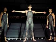 FILE - American Olympic medalists Amanda Beard, left, Natalie Coughlin, right, and Michael Phelps pose in Speedo &ldquo;LZR Racer&rdquo; swimsuits during a news conference introducing the suits in New York, Feb. 12, 2008. The iconic LZR Racer, the swimsuit that Michael Phelps wore while winning eight golds medals at the Beijing Olympics, is still revered around Speedo&rsquo;s design center.