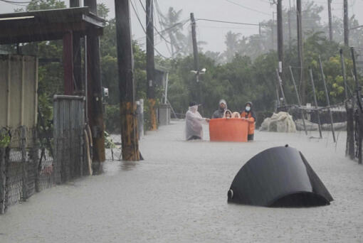 This photo released by Pingtung Fire Department shows, local residents being evacuated during floods after Typhoon Gaemi made landfall in Pintung county, Taiwan, Thursday, July 25, 2024.