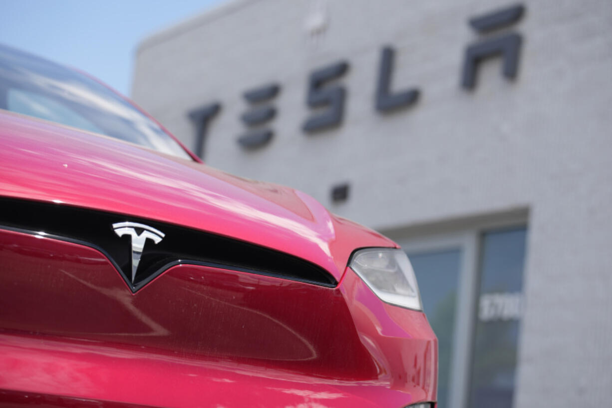 FILE - A Model X sports-utility vehicle sits outside a Tesla store in Littleton, Colo., June 18, 2023. An air quality board has ordered electric car manufacturer Tesla to stop illegally polluting the air in the San Francisco Bay Area.