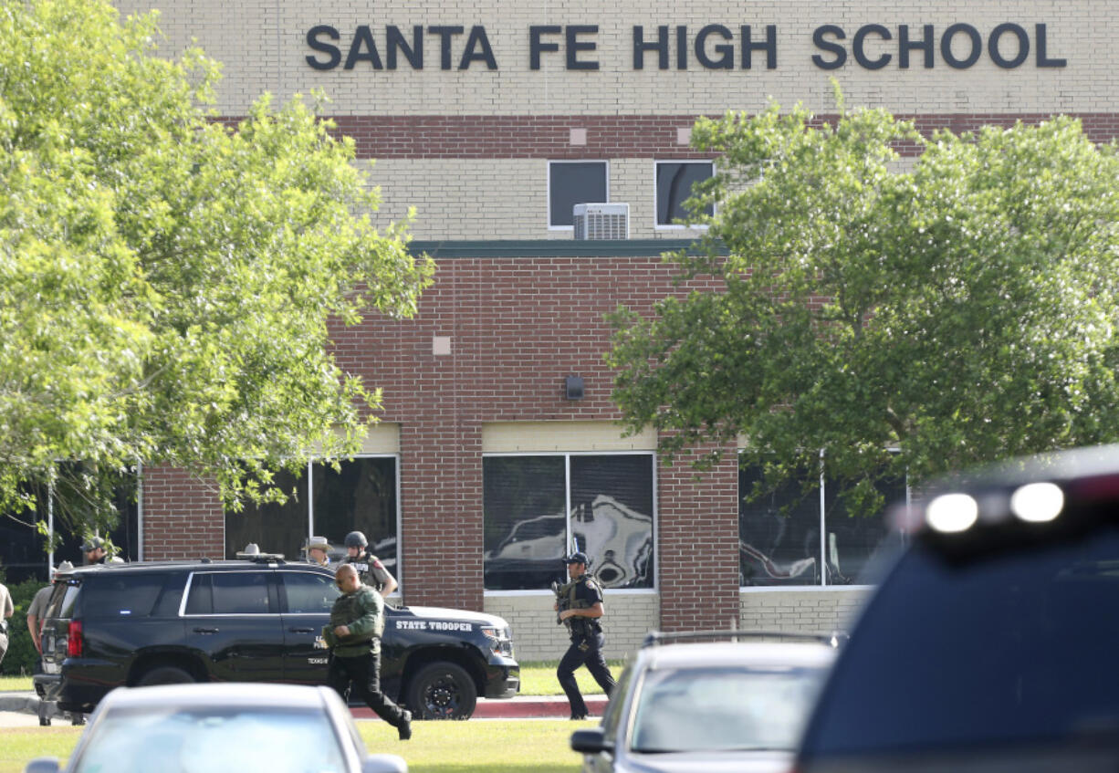 FILE - Law enforcement officers respond to Santa Fe High School after an active shooter was reported on campus in Santa Fe, Texas, May 18, 2018. A lawsuit accusing the parents of a former Texas high school student of negligence for not securing weapons he allegedly used in a 2018 shooting at his campus that killed 10 people was set to go before a jury on Wednesday, July 31, 2024.