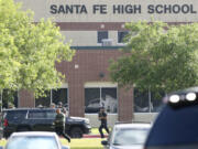 FILE - Law enforcement officers respond to Santa Fe High School after an active shooter was reported on campus in Santa Fe, Texas, May 18, 2018. A lawsuit accusing the parents of a former Texas high school student of negligence for not securing weapons he allegedly used in a 2018 shooting at his campus that killed 10 people was set to go before a jury on Wednesday, July 31, 2024.