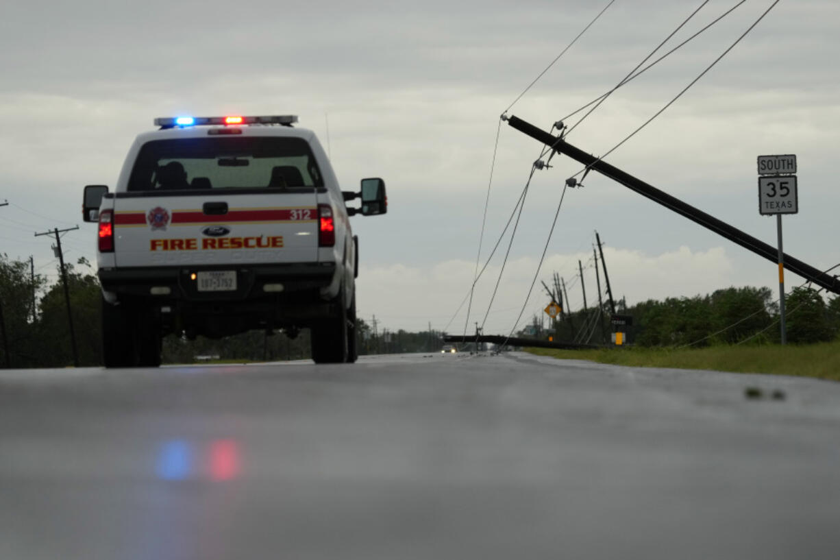 Power lines downed by the effects of Hurricane Beryl block a highway near Palacios, Texas, Monday, July 8, 2024.