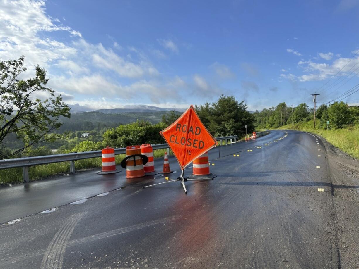 A sign warns of a road closed by flooding in Marshfield, Vt., Thursday, July 11, 2024.
