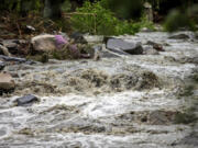 The Winooski River is seen flooded in Plainfield, Vermont. The village was badly hit by the flash flood last night, destroying two bridges and plenty of private houses, Thursday, July 11, 2024.