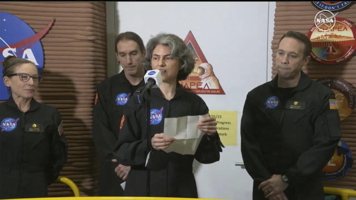 In this image made from video provided by NASA, Anca Selariu, a crew member of the first CHAPEA mission, speaks in front of other members, from left to right, Kelly Haston, Ross Brockwell, and Nathan Jones, Saturday, July 6, 2024, at Johnson Space Center in Houston, Texas. The crew of a NASA mission to Mars emerged from their craft after a yearlong voyage that never left Earth. The four volunteers crew members spent more than 12 months inside NASA&rsquo;s first simulated Mars environment at Johnson Space Center in Houston, coming out of the artificial alien environment Saturday.